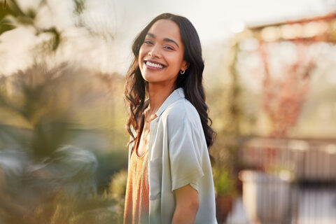 happy woman outisde smiling